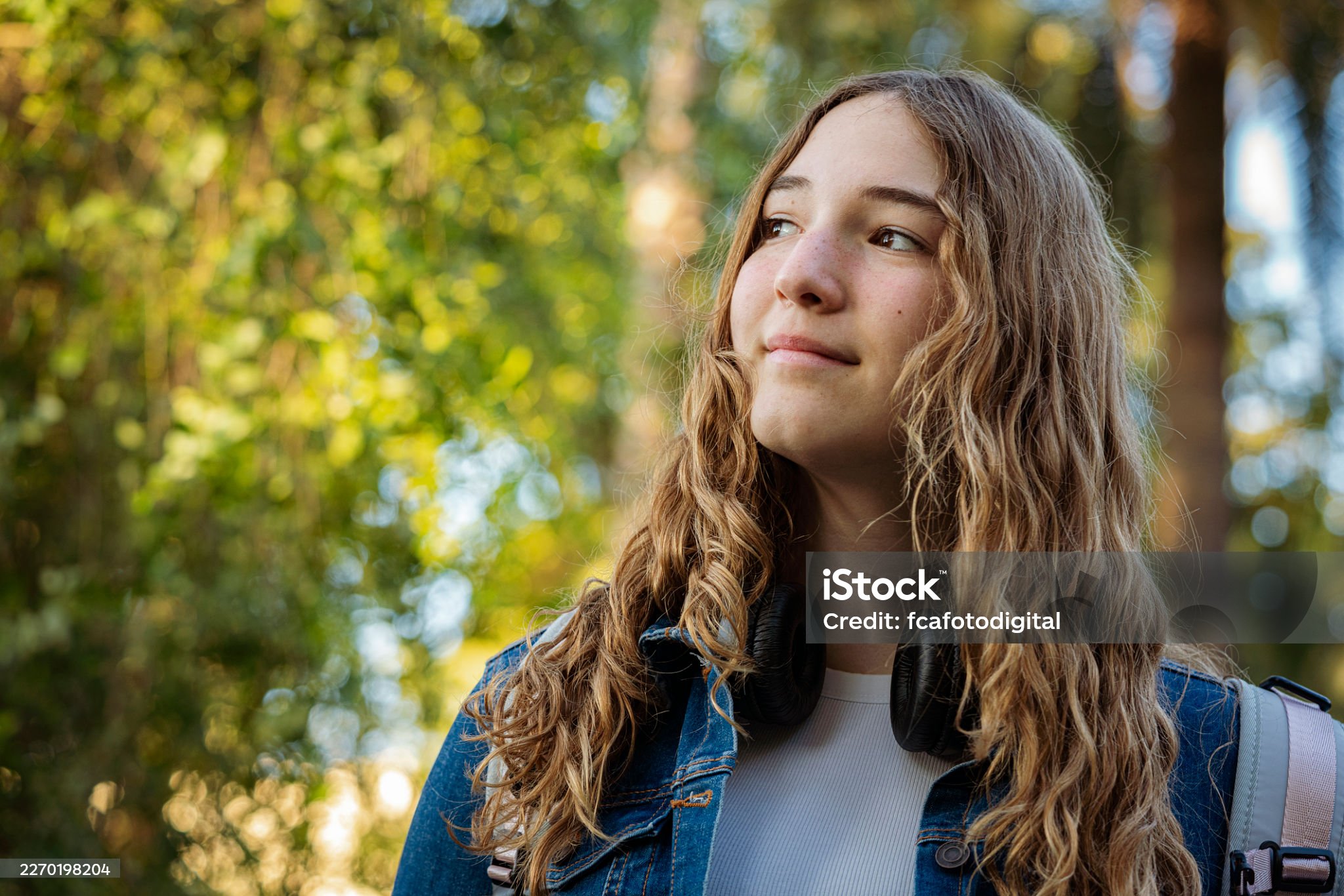 A young woman pausing in thought outdoors