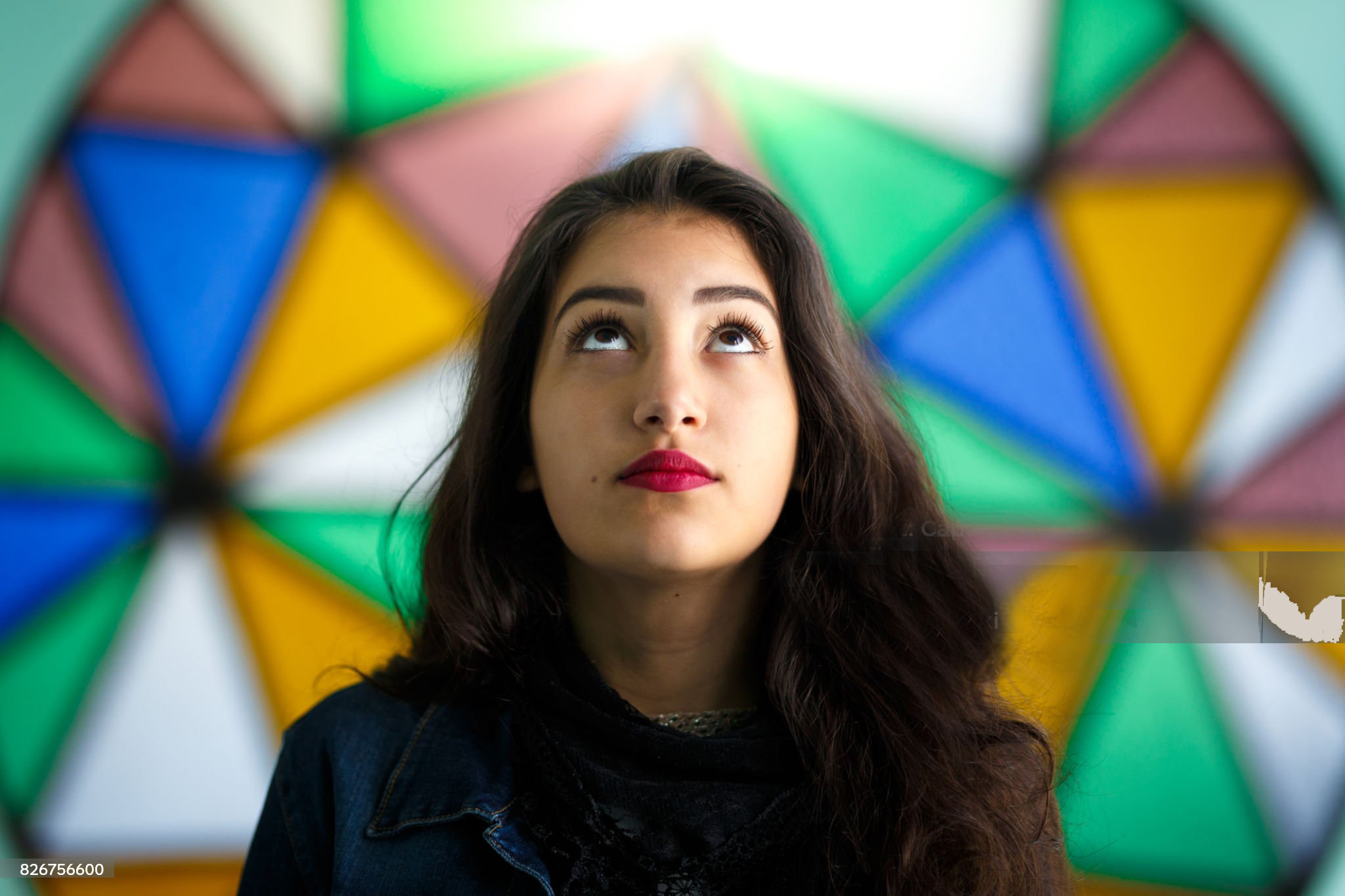 A young person looking thoughtfully upward