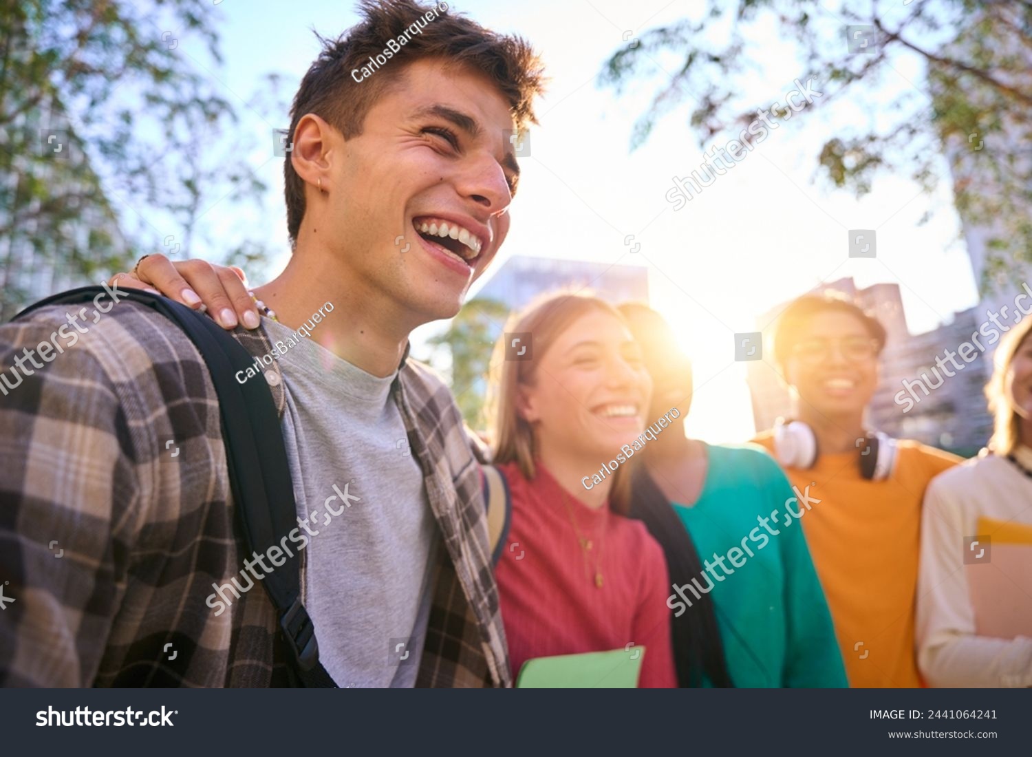 Happy university students smiling together outdoors